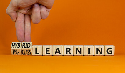Hybrid or in-class learning symbol. Businessman turns cubes, changes words hybrid learning to...