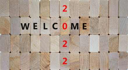 2022 welcome new year symbol. Wooden blocks with words 'Welcome 2022'. Beautiful wooden background, copy space. Business, 2022 welcome new year concept.