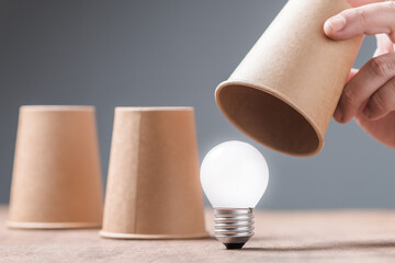 Closeup hand reveal where the light bulb is in three cups shell game, helpful tips, reveal the...