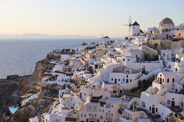 Oia, Santorini, Greece, 9 August 2021: cityscape with white traditional houses, hotels and mills.