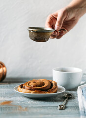cup of coffee with cinnamon bun