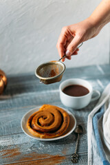 cup of coffee with cinnamon bun