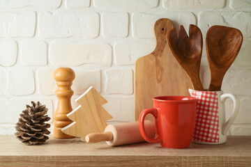 Fototapeta na wymiar iKichen utensils and coffee cup on wooden shelf. Christmas and New Year holiday mock up for design