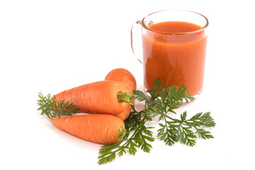 On an isolated white background a glass with carrot saturated healthy juice and fresh carrots. 