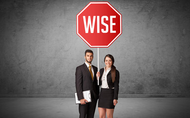 Young business person holding road sign