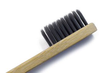 Wooden bamboo toothbrush with black bristles. Natural eco friendly zero waste item on white background