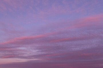 Fototapeta na wymiar Dramatic sunrise, sunset pink violet blue sky with clouds background texture
