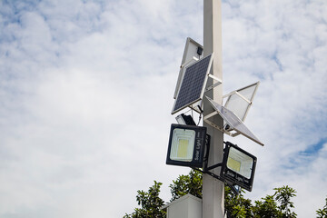 The solar cell device is mounted on the pole and the light is connected to the solar cell. - obrazy, fototapety, plakaty