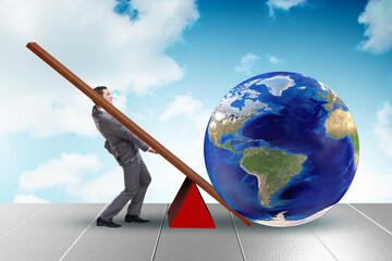 Businessman lifting the earth in challenge concept