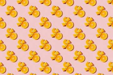 Fruit pattern of fresh ripe slice orange on pink background. Top view, copy space for your text. Fruit composition, healthy concept.