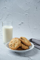 Glass of milk and cookies with white background