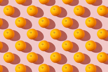 Fruit pattern of fresh ripe slice orange on pink background. Top view, copy space for your text. Fruit composition, healthy concept.