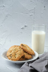 Glass of milk and cookies with white background