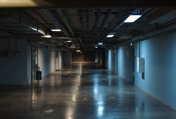 Underground floor of a shopping center. The corridor. Reflections. Technical. Atmosphere. Lighting