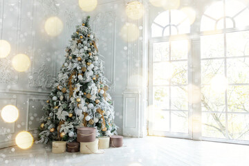 Classic christmas New Year decorated interior room New year tree. Christmas tree with gold decorations. Modern white classical style interior design apartment, large window. Christmas eve at home.