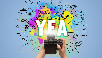 Close-up of a hand holding digital camera with abstract drawing