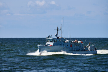 Coastguard, rescue support patrol boat for defense, military ship on high blue seas, Russian Navy