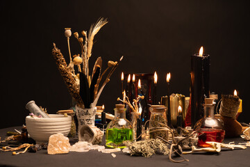 Witchcraft still life with black burning candles selective focus. Esoteric gothic and occult witch...