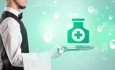 Handsome young waiter in tuxedo holding healthcare icons on tray