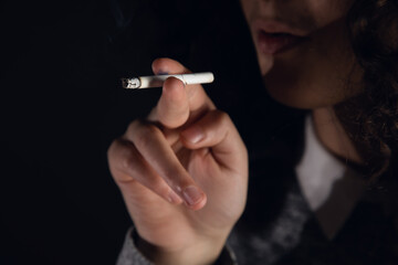 closeup woman hand smoking cigarette