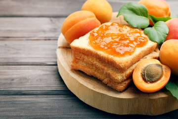 Apricots and toast with jam on brown background