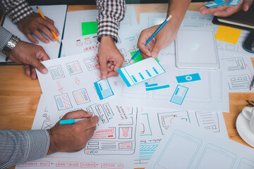 UX or UI designers designing on their smartphone application layout prototype project.