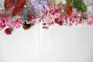 Dried flowers on rustic wooden planks background