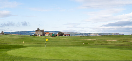 Close up of a hole or  putting green on a cliff top golf course in North Yorkshire, UK