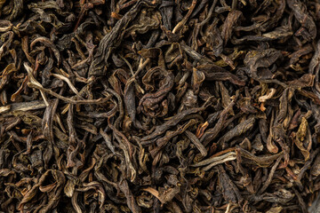 Heap of dry tea leaves. Dried black tea. Textured background of dried leaves of aromatic black tea...