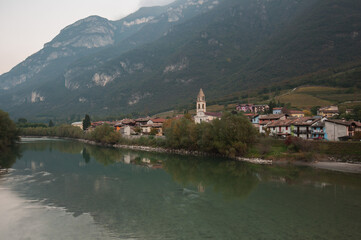 Fototapeta na wymiar hamlet on the Adige river in autumn. 