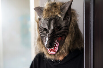 man with werewolf mask and black dress. Halloween