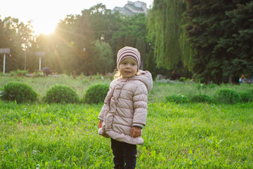 Little cute girl in the park, blurred background