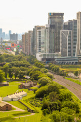 Aerial view of Fort York with lush green fields, urban forest, and skyscrapers