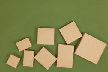 Christmas crafts made of paper holiday boxes on a green background. Christmas winter holiday greetings, advent calendar. flat lying