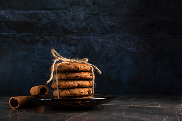 Cookies with chocolate pieces and cinnamon on a dark background 