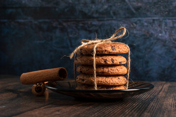 Cookies with chocolate pieces and cinnamon on a dark background 