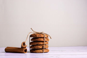 Cookies with pieces of chocolate , cinnamon on a light background