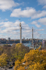 Obraz premium View with a skyline of the district Södermalm in Stockholm. Towers, buildings and roller coaster in the fore ground a colorful autumn day
