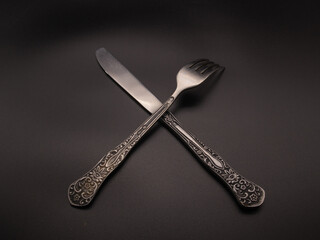Spoon and fork on dark background