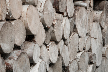 stacked chopped firewood. timber bars at a sawmill. wood background