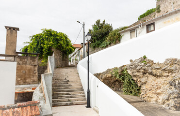 Fototapeta na wymiar a street and a white wall in Montemor-o-Velho, district of Coimbra, Beira Litoral province, Portugal