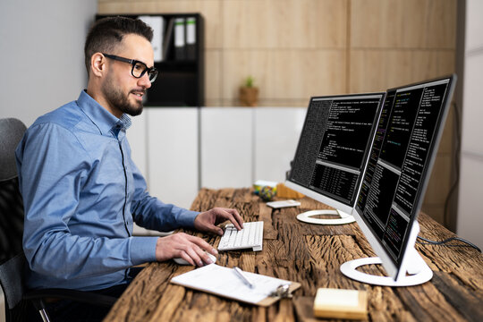 Coder Using Computer At Desk