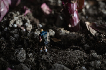 Small miniature hiking model in the dirt
