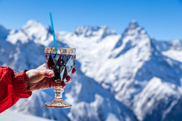 Glass of mulled wine against the backdrop of beautiful mountains
