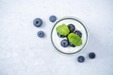 Greek yogurt blueberry parfaits with fresh berries and mint leaves