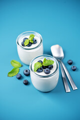 Greek yogurt blueberry parfaits with fresh berries and mint leaves