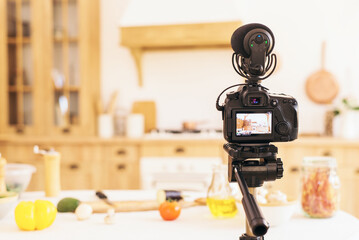 Stylish kitchen with minimalist interior. Professional camera takes photo of blurred kitchen in...