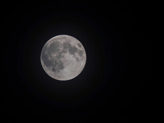 Fototapeta na wymiar Imagen de la luna llena sobre el cielo negro. 
