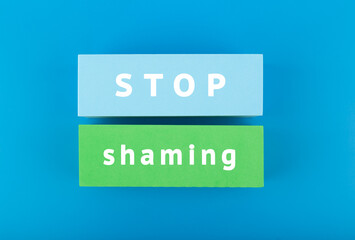 Stop shaming minimal concept. Minimal flat lay with text on blue background