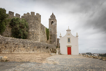 Chapel of St. Anthony and the clock tower on the castle wall of Montemor-o-Velho, district of Coimbra, Beira Litoral province, Portugal